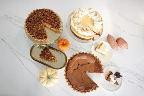 Pumpkin praline pie, sweet potato cheesecake and chocolate chess pie on a marble table
