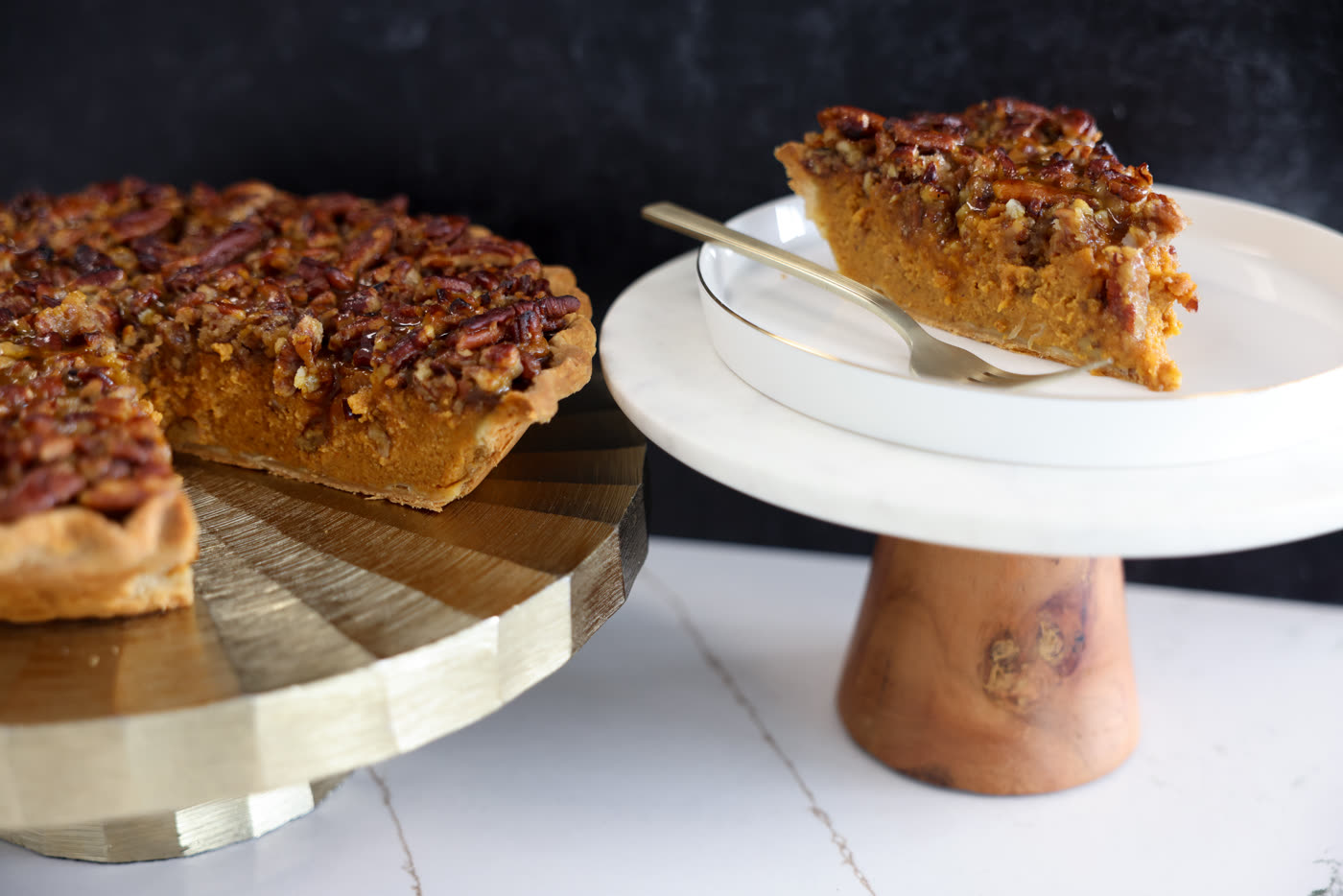 Pumpkin praline pie with a crunchy pecan topping, one slice served on a cake stand